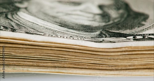 Growing up and down bundle of 100 dollars bills, macro view, time lapse