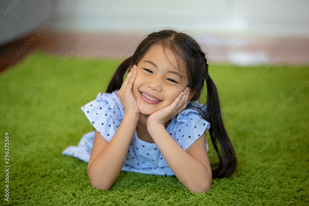 Little girl play on green carpet in living room Little girl play on green carpet in living room