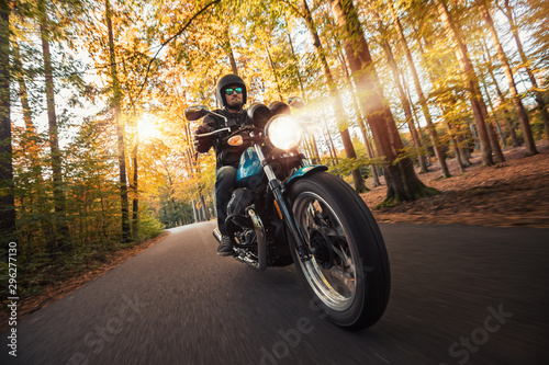 Motorcycle driver riding in foreste landscape