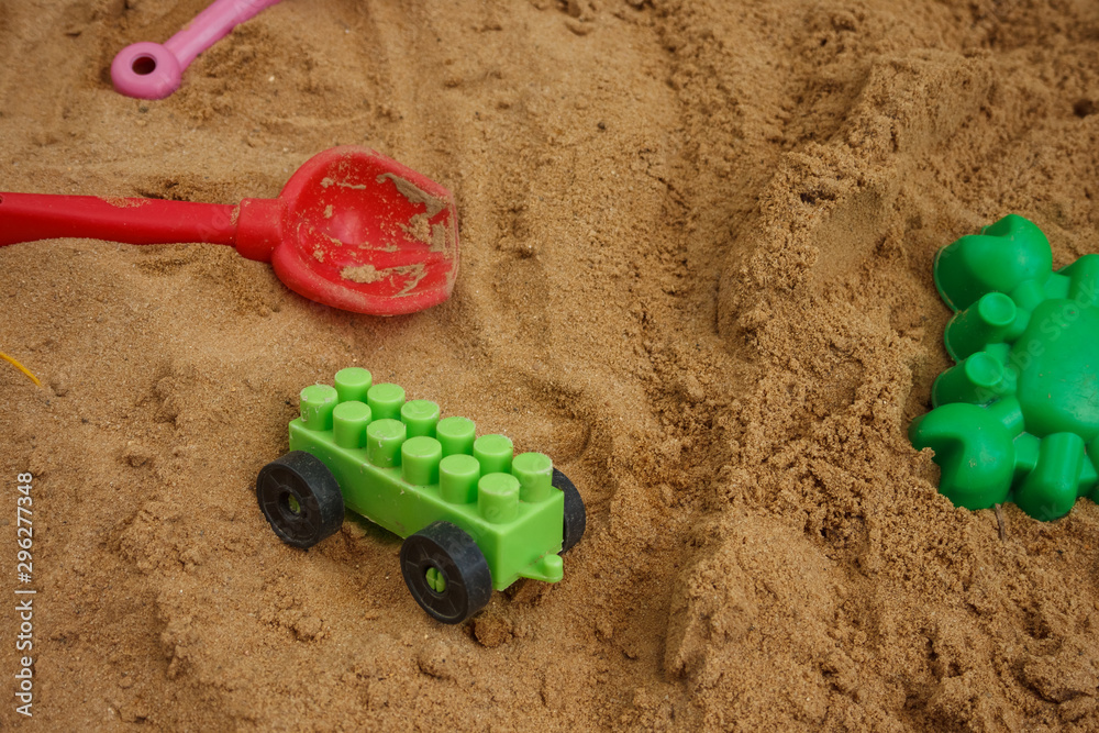 Bright colored children's toys in the sandbox. Close-up. Toy. Background. Bright colored children's toys in the sandbox. Close-up. Toy. Background.