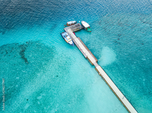 Aerial view of the docking dock of the boats and the reef around