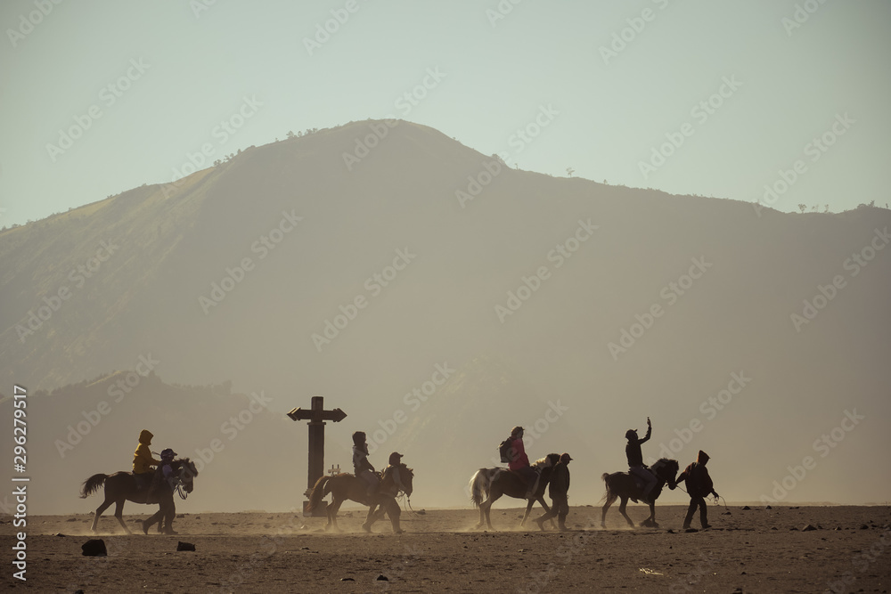 Fototapeta premium Horse riding in the dust, horsemen riding in sandstorm, Sand dune, desert