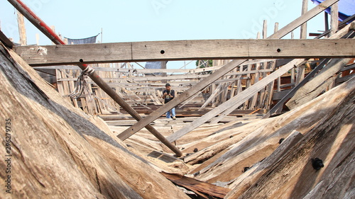 Timber shipbuilder working while working at a shipyard, Batang Indonesia,