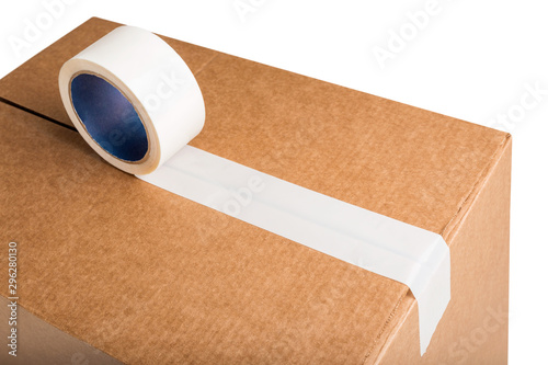 Closeup of cardboard box with white adhesive tape isolated on white background