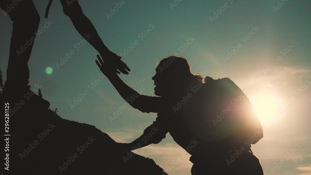 teamwork help business travel silhouette slow motion video concept. Helping hand silhouette between two climbers. teamwork group of tourists lends a helping hand climb the cliffs mountains. couple man