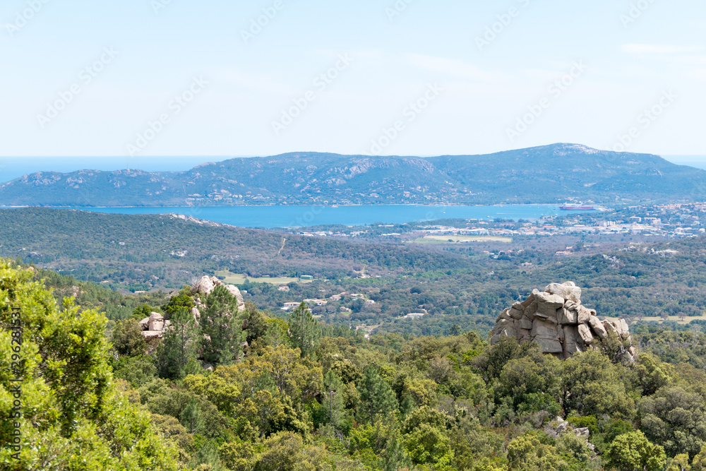 Landscape shot with green forests, mountains and a blue sky
