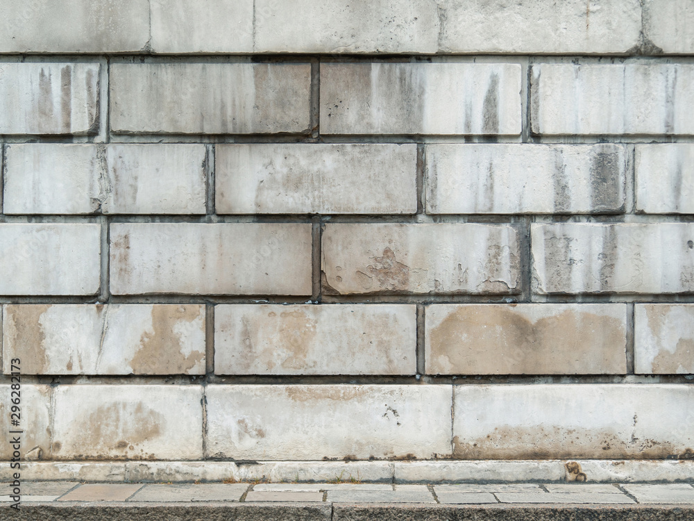 Fototapeta premium White brick wall background and concrete floor.