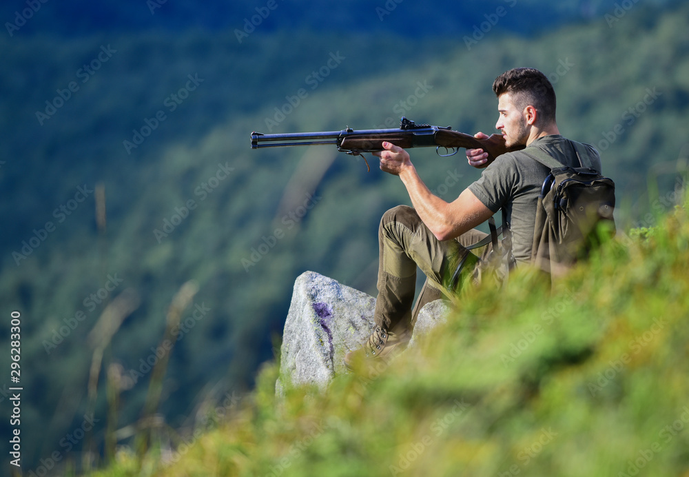 soldier in the field. combat readiness. muscular man hold weapon. purpose and success. military style. male in camouflage. army forces. sniper reach target mountain. man ready to fire. hunter hobby soldier in the field. combat readiness. muscular man hold weapon. purpose and success. military style. male in camouflage. army forces. sniper reach target mountain. man ready to fire. hunter hobby