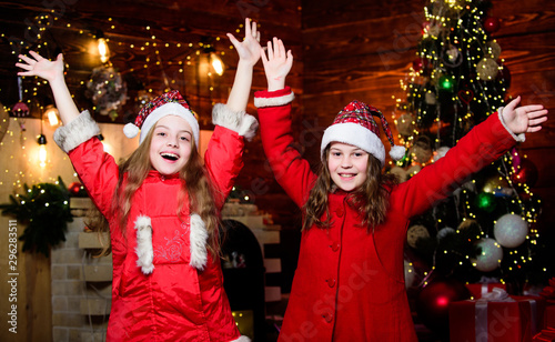 Elf children. Xmas children. Christmas time. Elf children. Little girl sisters in red hats. Christmas elf. Happy new year. Children look like elf. Santa claus little girls sisters. Best time together photo