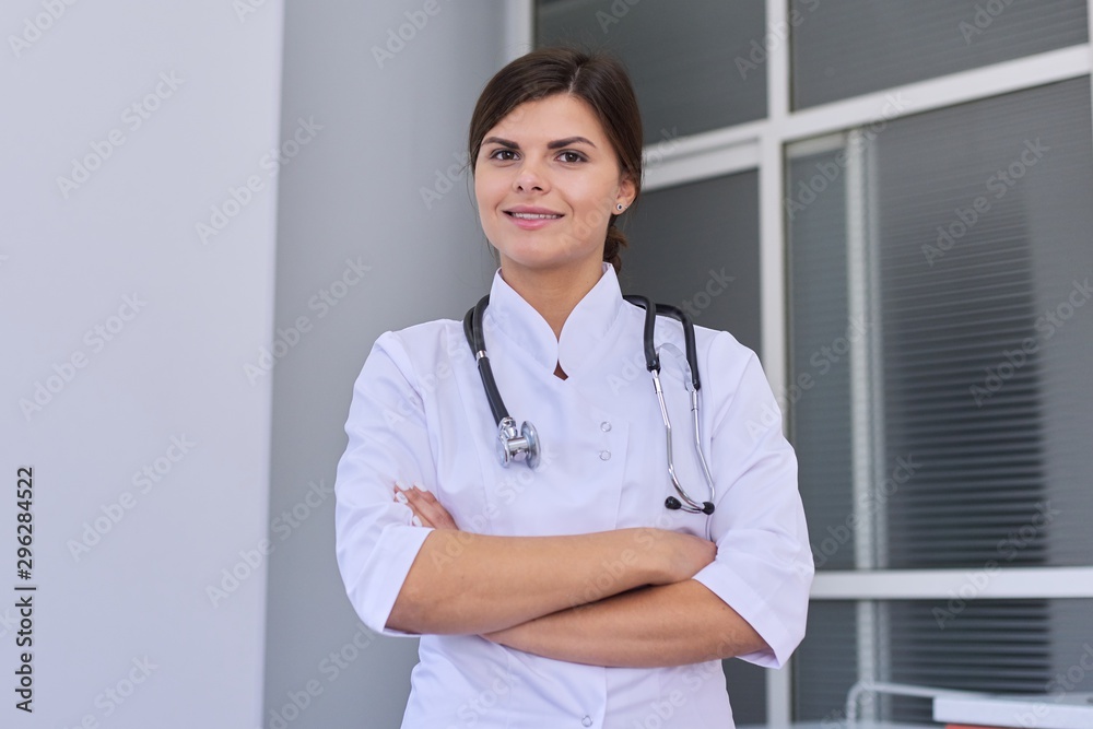 Portrait of confident young female medic with stethoscope with crossed arms Portrait of confident young female medic with stethoscope with crossed arms
