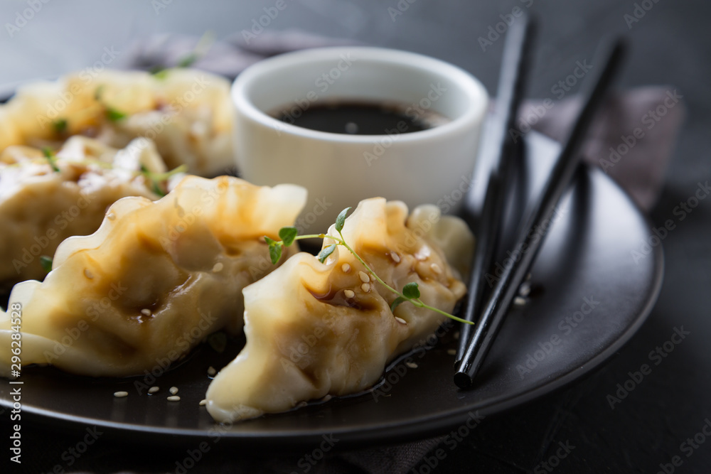 Wonton stuffed with soy sauce on a dark table