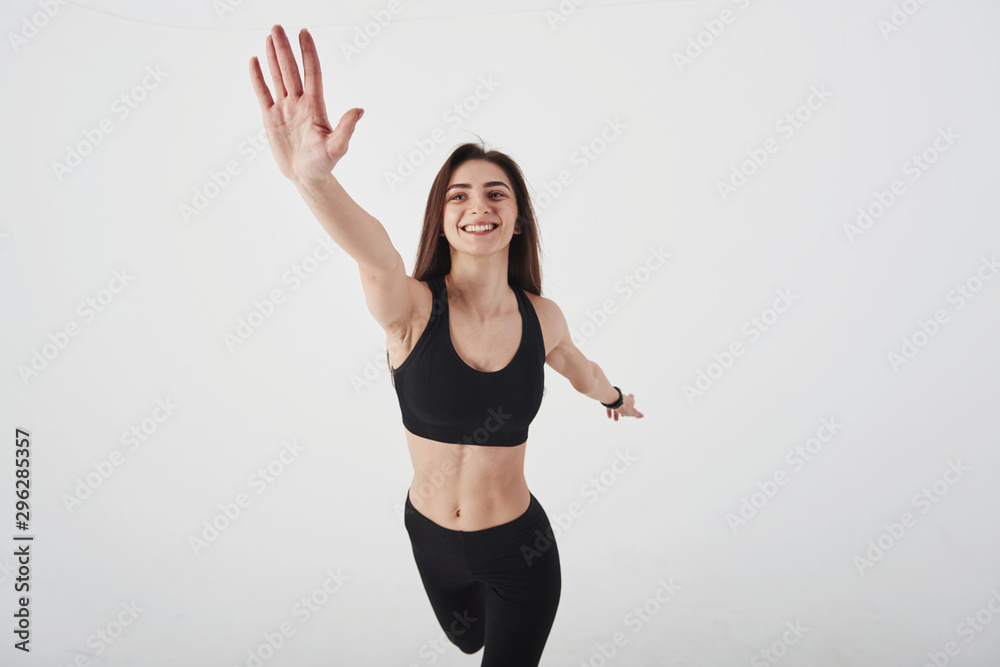 Hello there, gesture. Young beautiful woman in the studio standing against white background