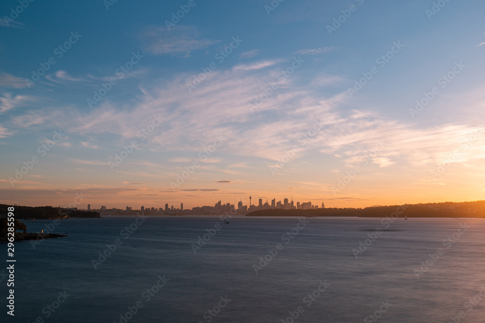 Sunset view over Sydney skyline from the distance.