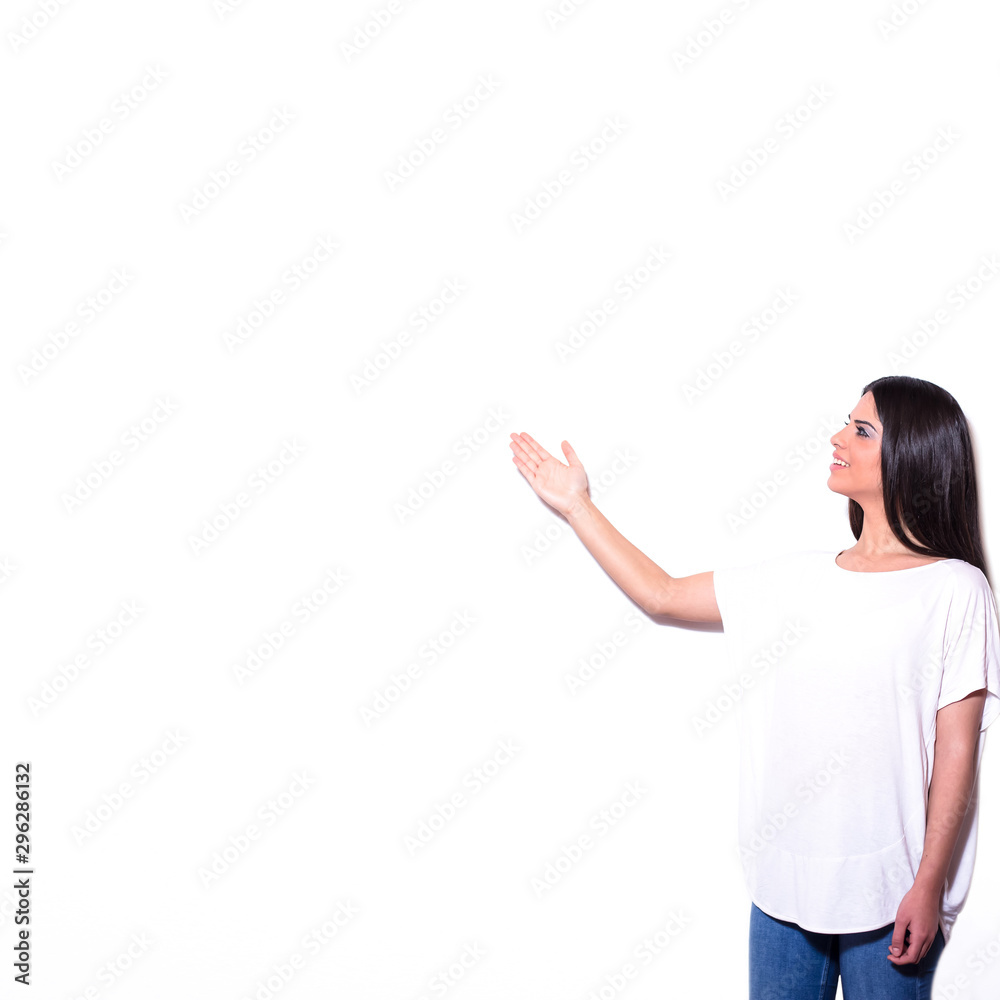 Young happy smiling woman presenting at side isolated on white background. Young happy smiling woman presenting at side isolated on white background.