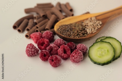 Sample foods from low-GI PCOS (Polycystic Ovary Syndrome) diet. Lentils, chia seeds, sunflower seeds, buckwheat pasta, raspberries and cucumber. 