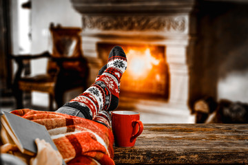Table top with blurred fireplace and cosy home interior background.