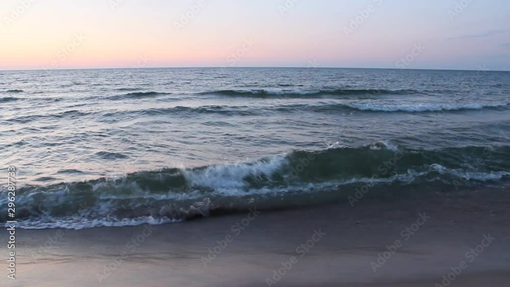 Sea waves on sand. Ocean waves beat against waves on beach. Sea water. Beautiful waves of Baltic sea on sandy beach. Splashing sea waves. Vacation concept. Marine beach. Vacation concept Sea waves on sand. Ocean waves beat against waves on beach. Sea water. Beautiful waves of Baltic sea on sandy beach. Splashing sea waves. Vacation concept. Marine beach. Vacation concept