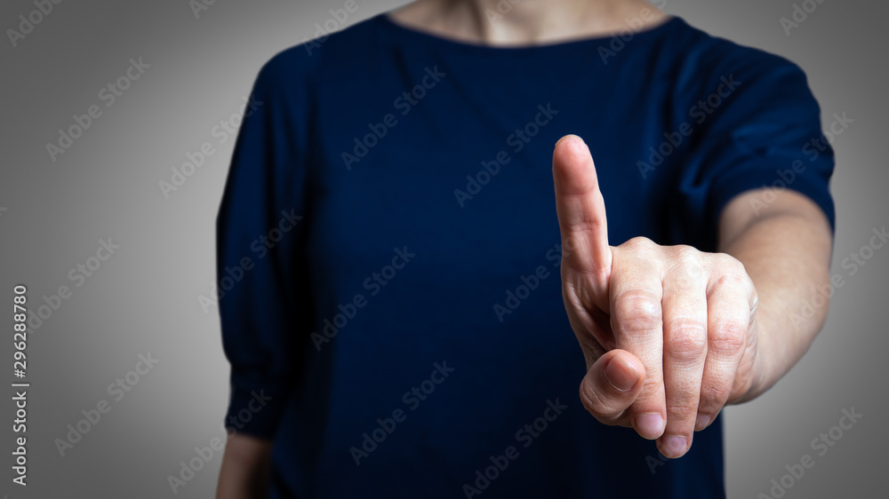 Woman with pointing to something or touching a touch screen Woman with pointing to something or touching a touch screen