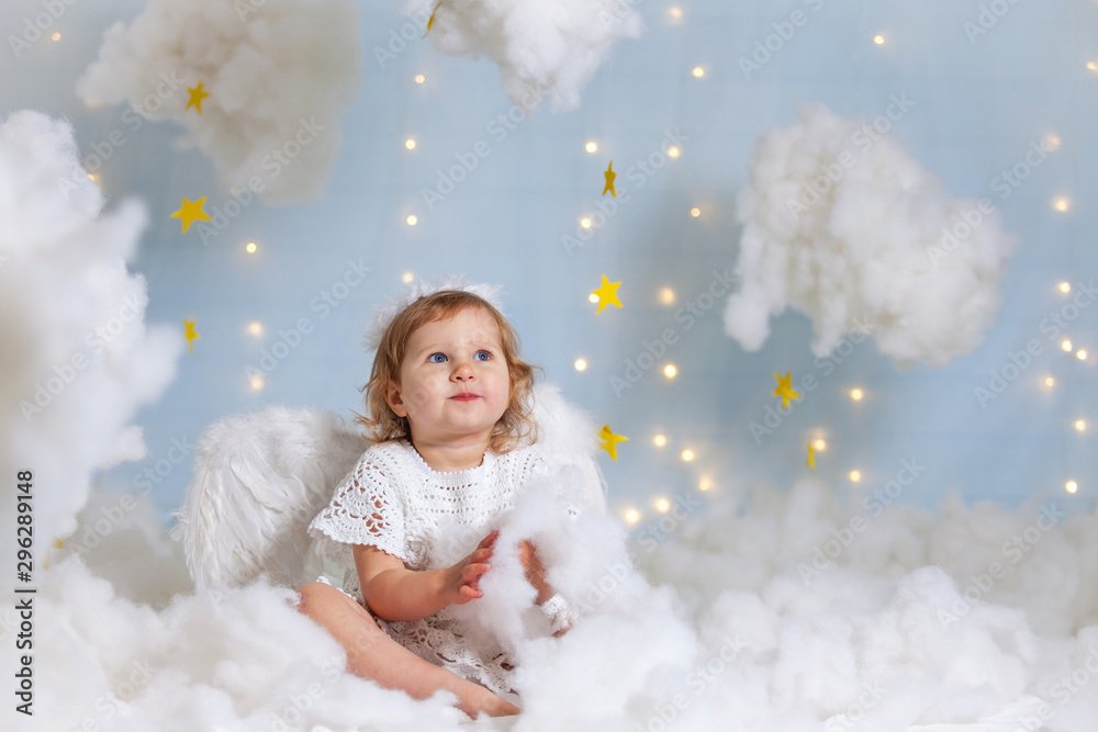 angel child is sitting the clouds looks down angel child is sitting the clouds looks down