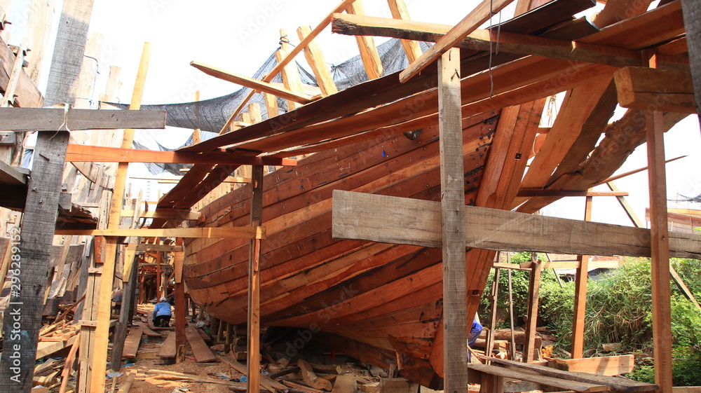Timber shipbuilder working while working at a shipyard, Batang Indonesia, Timber shipbuilder working while working at a shipyard, Batang Indonesia,