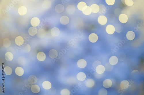 Defocused background with blurred Christmas light. New year magic bokeh lights in cold tones