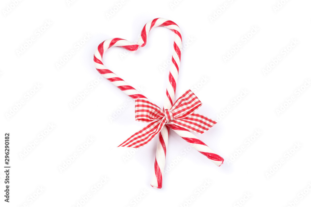 Sweet candy canes with bow isolated on white background Sweet candy canes with bow isolated on white background