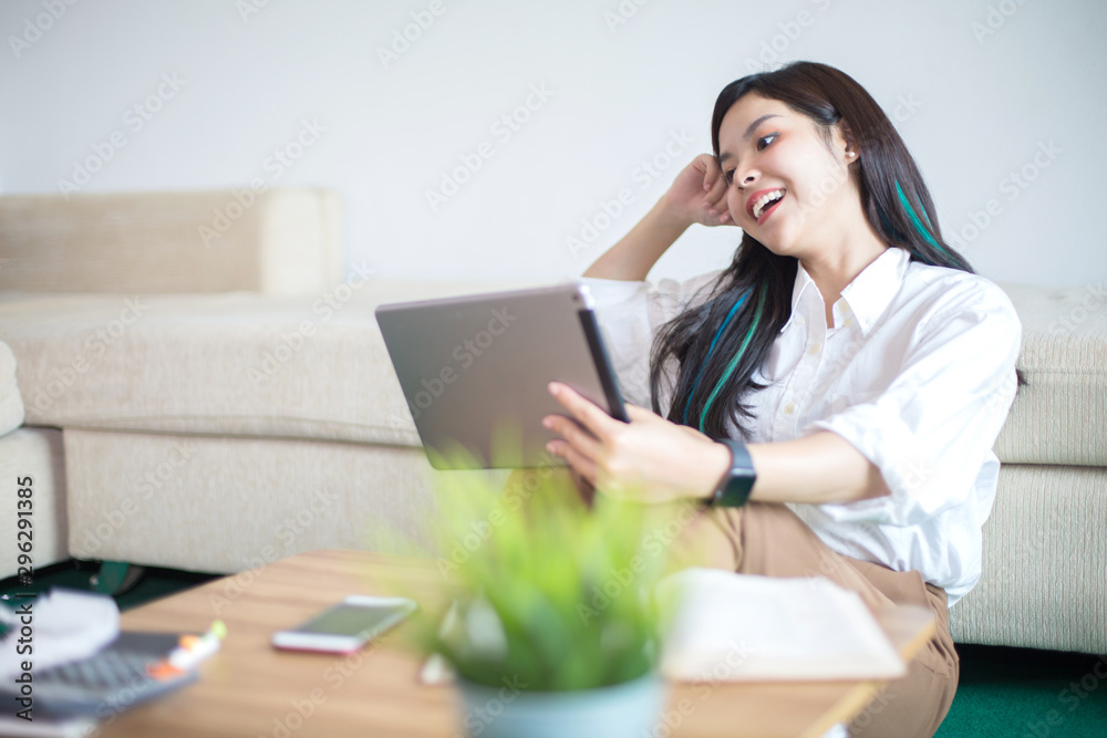 Young Asia women are using computers, books, phones, bills, cash and calculators. Online Inside her house Young Asia women are using computers, books, phones, bills, cash and calculators. Online Inside her house