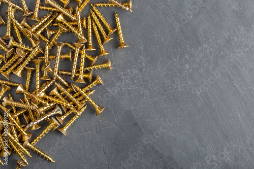 Screws metal steel on grey slate background
