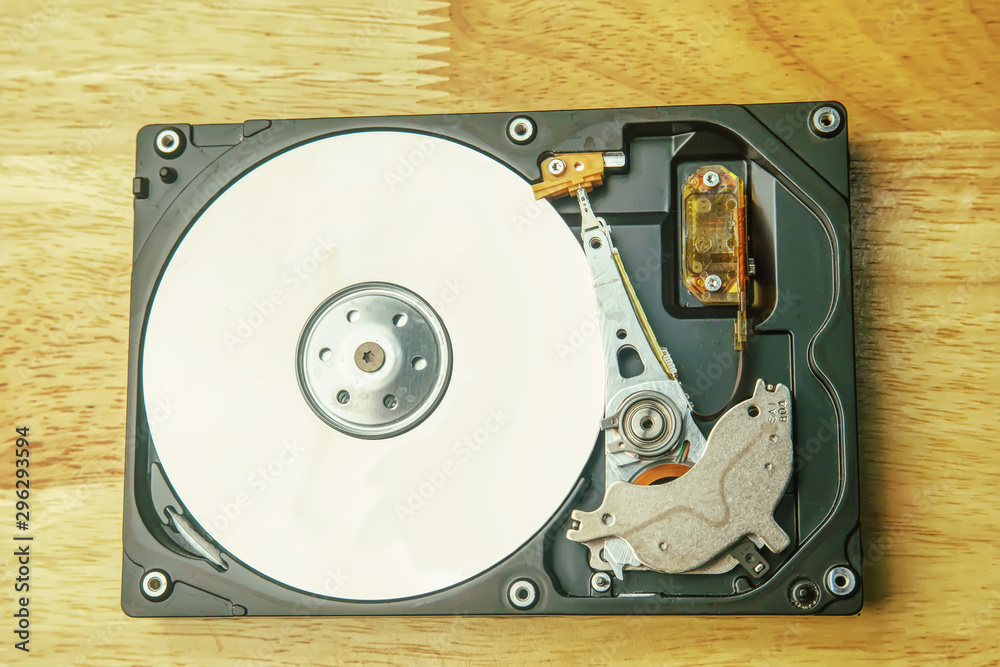 Hard disk drive removable case for repair on the wooden desk. Hard disk drive removable case for repair on the wooden desk.