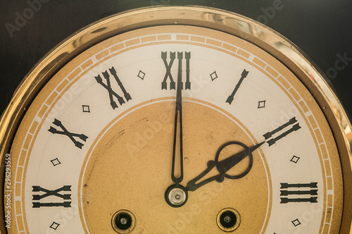Close up old antique classic clock. Retro style. Vintage background.
