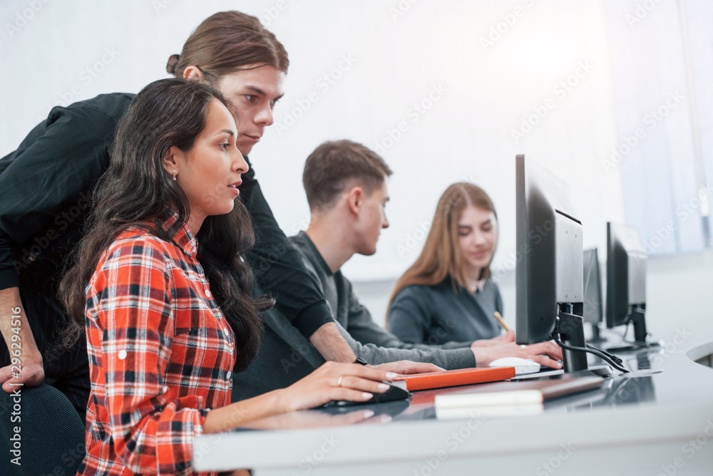 Fototapeta premium Here's my results. Group of young people in casual clothes working in the modern office