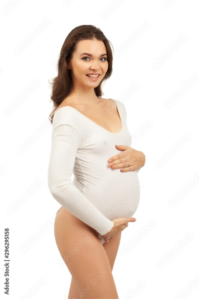 Pregnant woman in a white bodysuit on a white background. Pregnant woman in a white bodysuit on a white background.