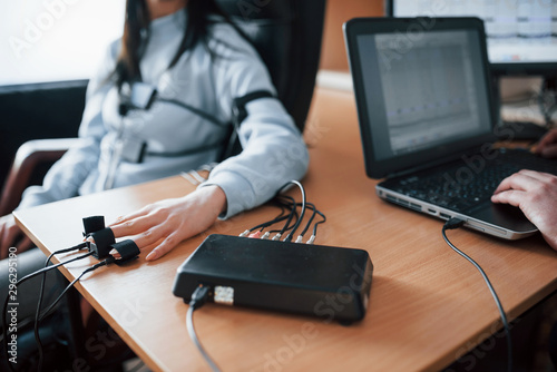Fidelity verification. Girl passes lie detector in the office. Asking questions. Polygraph test