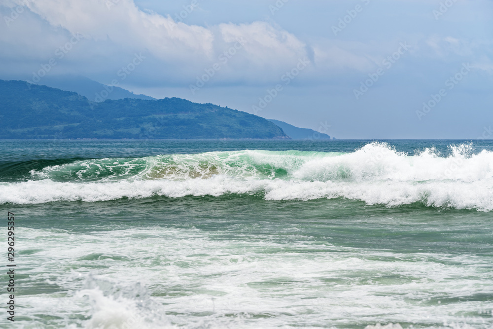 Big breaking wave on a sandy beach in Da Nang, Vietnam