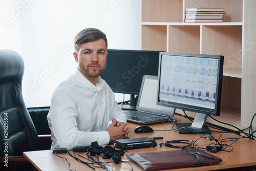 In the workplace. Polygraph examiner works with his lie detector's equipment