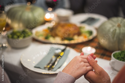 Holding hands near table with food