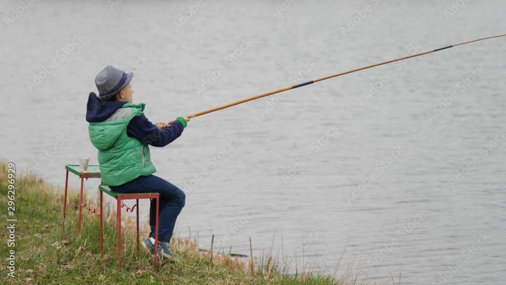 Child plays the fisherman catching big fish Child plays the fisherman catching big fish