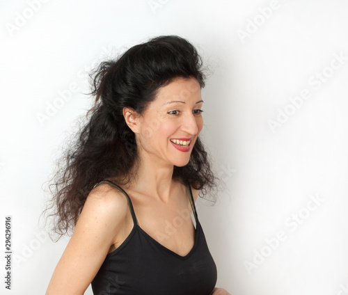 Disheveled attractive smiling young woman portrait on white background