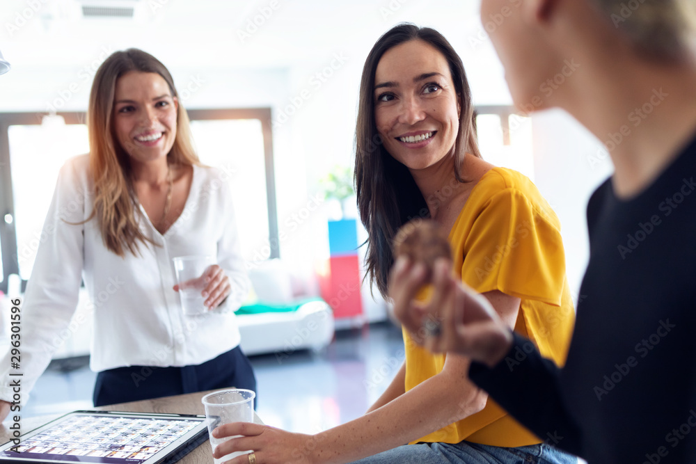Three young entrepreneur women taking a break and having a breakfast in the office. Three young entrepreneur women taking a break and having a breakfast in the office.