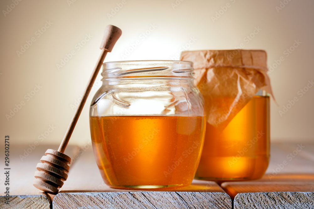 Honey Jar And Dripper on table. Remedy, sweetener concept. Honey Jar And Dripper on table. Remedy, sweetener concept.