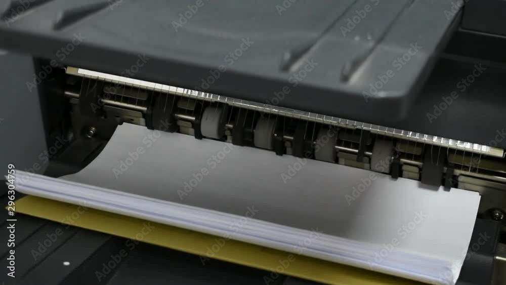 Photocopier machine running, pulling sheets to tray Photocopier machine running, pulling sheets to tray