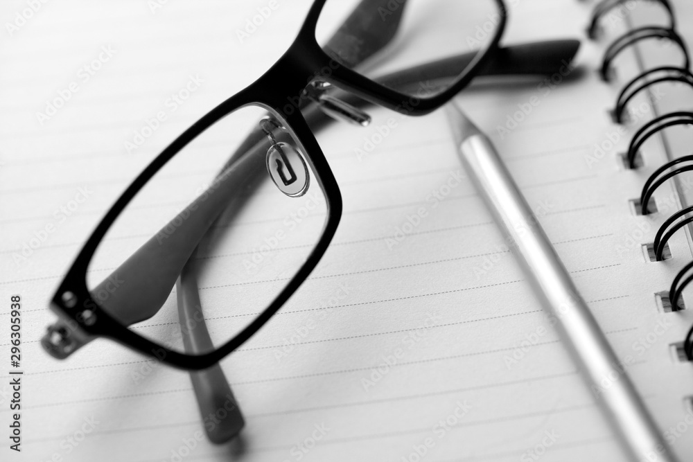 close up glasses on blank paper with pencil close up glasses on blank paper with pencil
