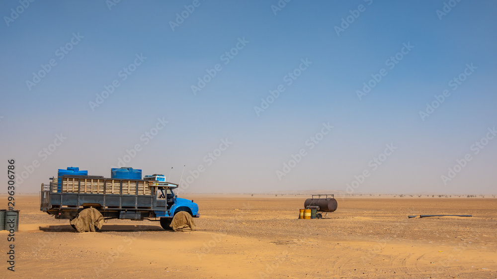 Water wagons and water barrels in the middle of the desert of Sudan