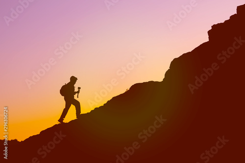 silhouette of a traveler in the mountains walking at the beginning of the mountain