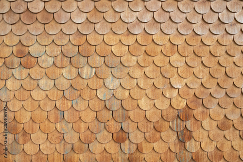 Traditional facade cladding with brown roof shingles
