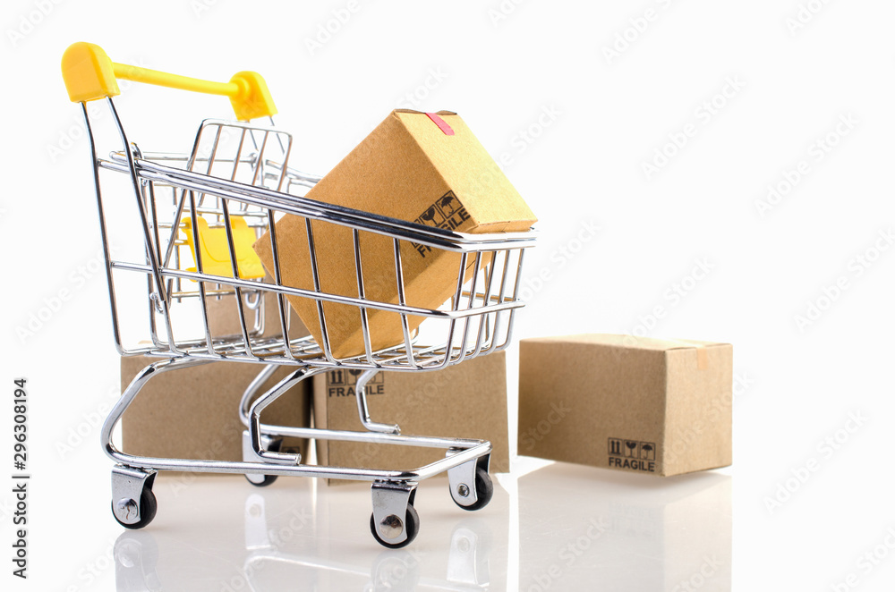 Paper boxes in a trolley on white background. Ideas online shopping is a form of electronic commerce that allows consumers to directly buy goods from a seller over the internet.