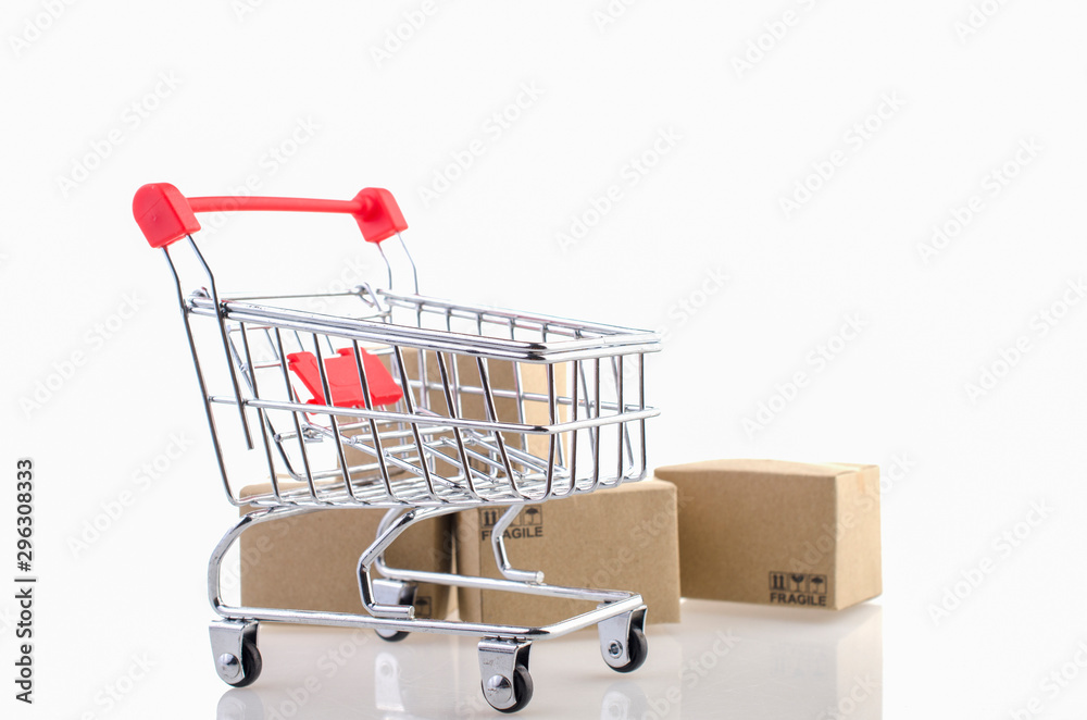 Trolley and paper boxeson white background. Ideas online shopping is a form of electronic commerce that allows consumers to directly buy goods from a seller over the internet. Trolley and paper boxeson white background. Ideas online shopping is a form of electronic commerce that allows consumers to directly buy goods from a seller over the internet.