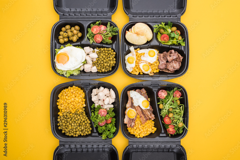 top view of eco packages with apples, vegetables, meat, fried eggs and salads isolated on yellow - obrazy, fototapety, plakaty 