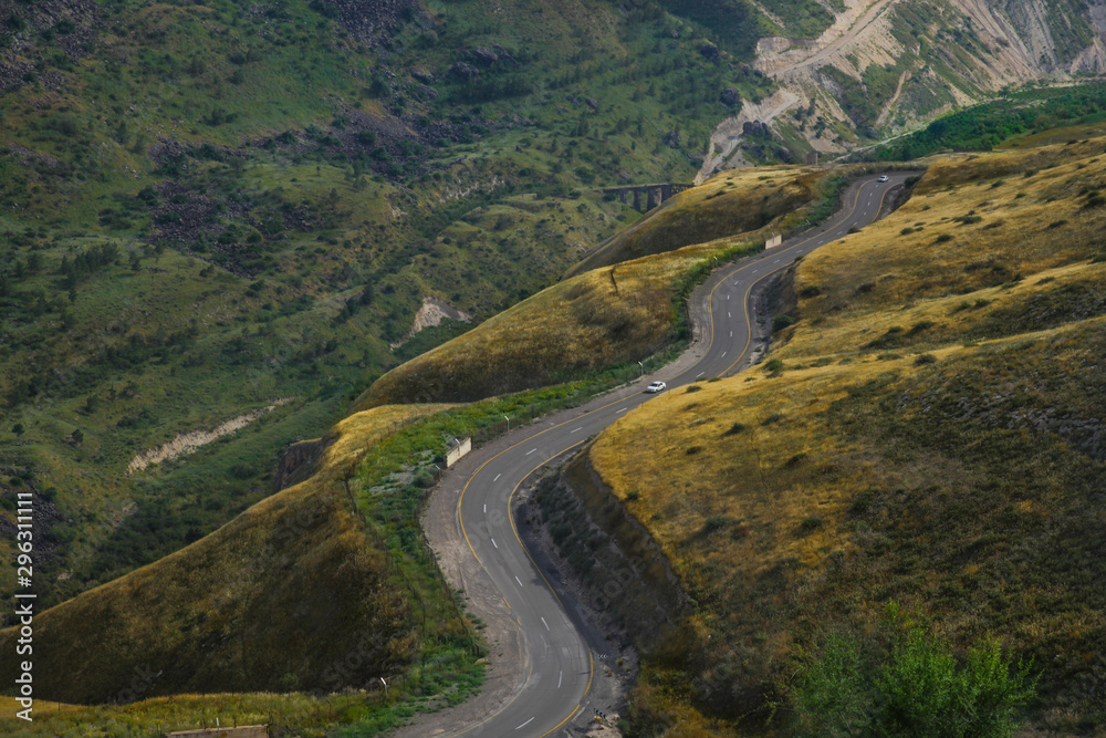 Fototapeta premium Road snaking through mountain landscape