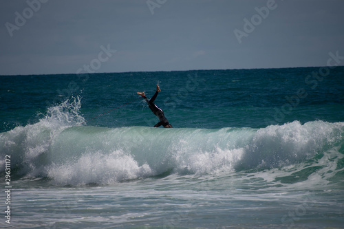 Person leaping over a wave
